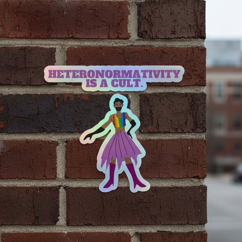 Holographic sticker on a brick wall shows a person in bold, vibrant clothes with the slogan: “Heteronormativity Is A Cult.”.