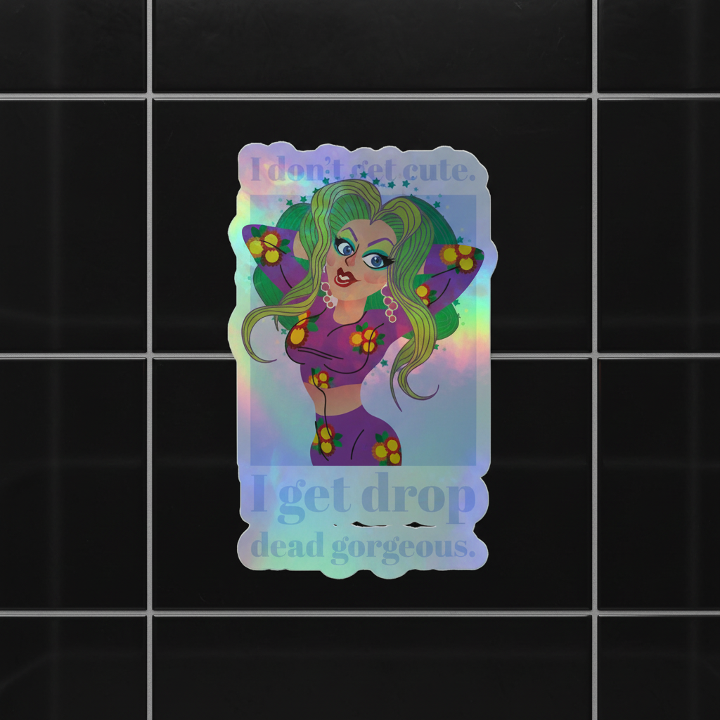 Holographic vinyl sticker with a queer cartoon: green hair, bold makeup, floral outfit on black tile. Text: "I don't get cute. I get drop dead gorgeous.