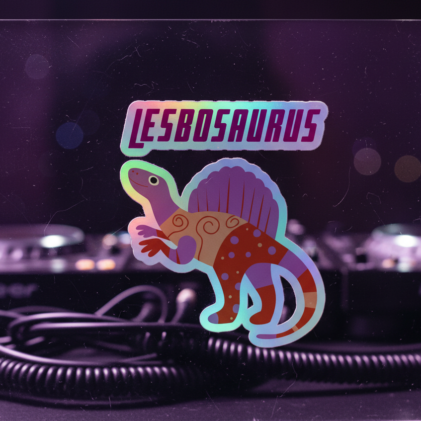 Holographic "LESBOSAURUS" sticker pops with a bright cartoon dino, sailback and polka dots, glowing on glass near DJ gear in purple light.