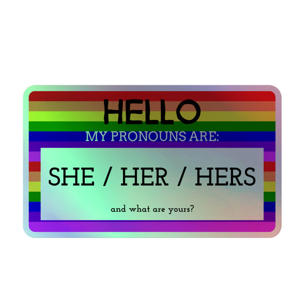Rectangular 'Hello My Pronouns Are She/Her/Hers' holographic sticker with a rainbow-striped border, inviting inclusive self-expression. Crafted from durable vinyl, it celebrates queer pride and identity with a vibrant, empowering shimmer.