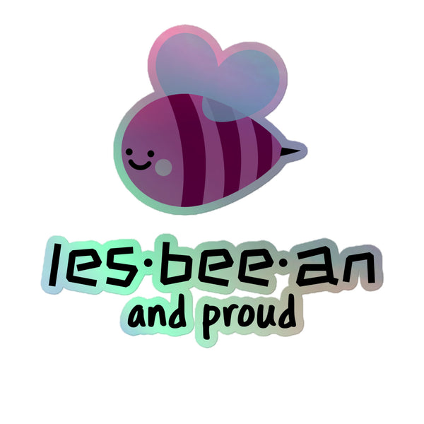 Les-bee-an And Proud Holographic Stickers feature a cute cartoon bee with heart-shaped wings, a purple-and-pink striped body, and a playful slogan, embodying vibrant queer pride and joyful self-expression.