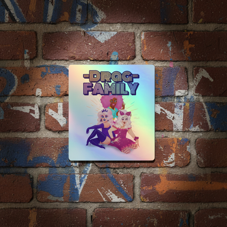 Poster print featuring "DRAG FAMILY" above three proud drag queens, glowing on a vibrant wall, serving up bold queer sticker vibes.