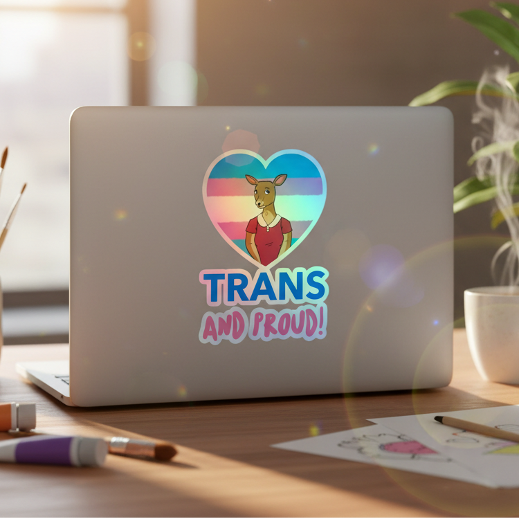 Heart-shaped holographic sticker with kangaroo and bold “TRANS AND PROUD!” on pastel blue, pink, white stripes; trans pride vibes.