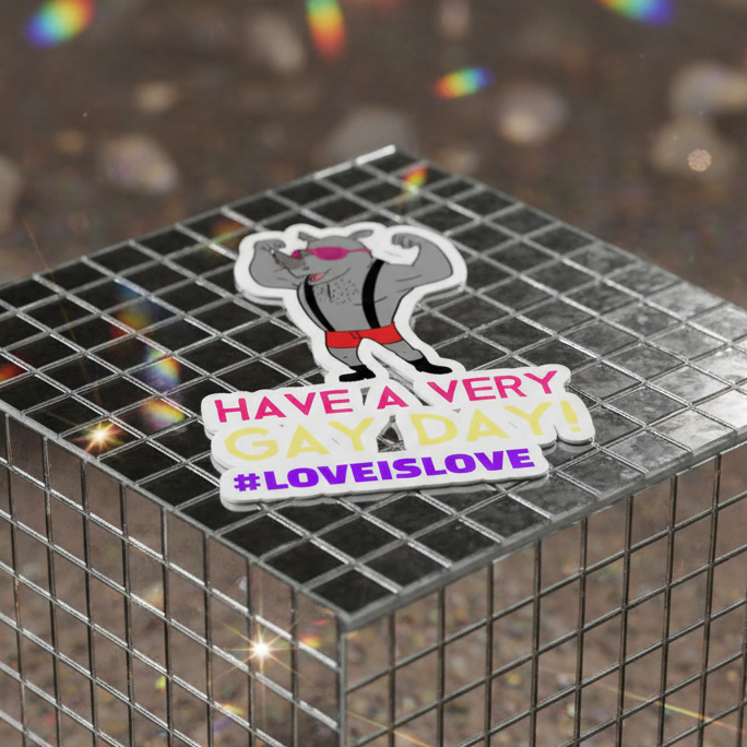 Bubble-Free Sticker showing a buff cartoon dog in pink shades, red shorts, and black vest flexing over “HAVE A VERY GAY DAY!” and “#LOVEISLOVE” on a rainbow-cube backdrop.