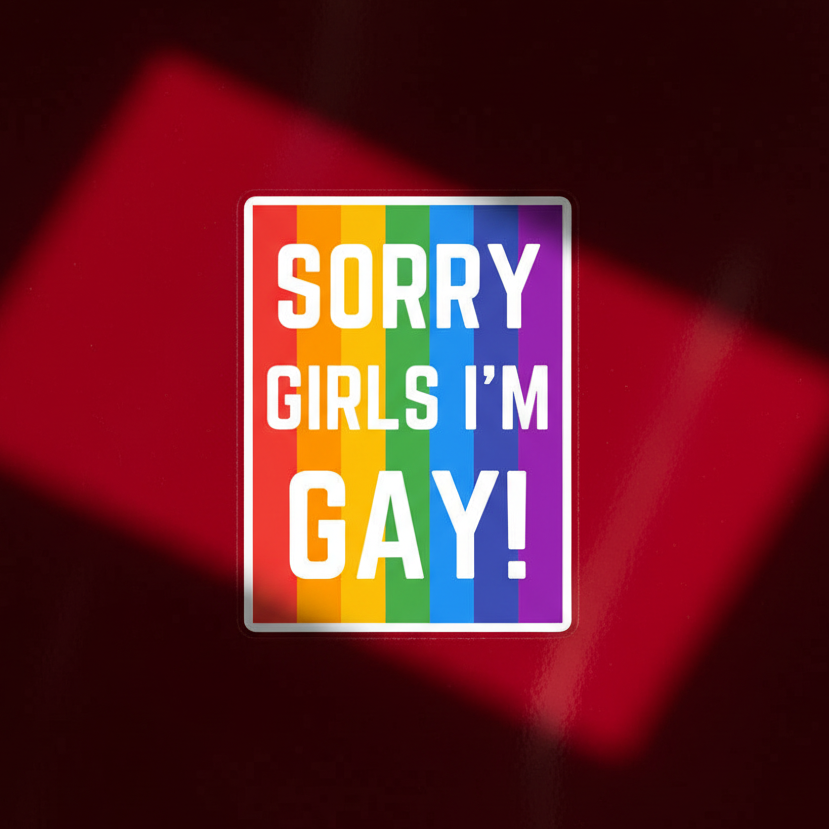 Bubble-free vinyl sticker with bold white “Sorry Girls I’m Gay!” lettering over rainbow stripes, on a dark red background with diagonal red lighting.