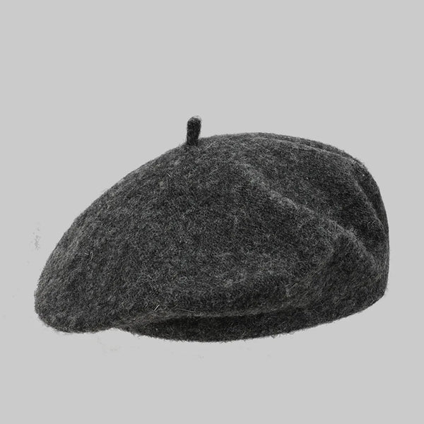 Dark gray wool beret with a small top stem, shown against a plain background