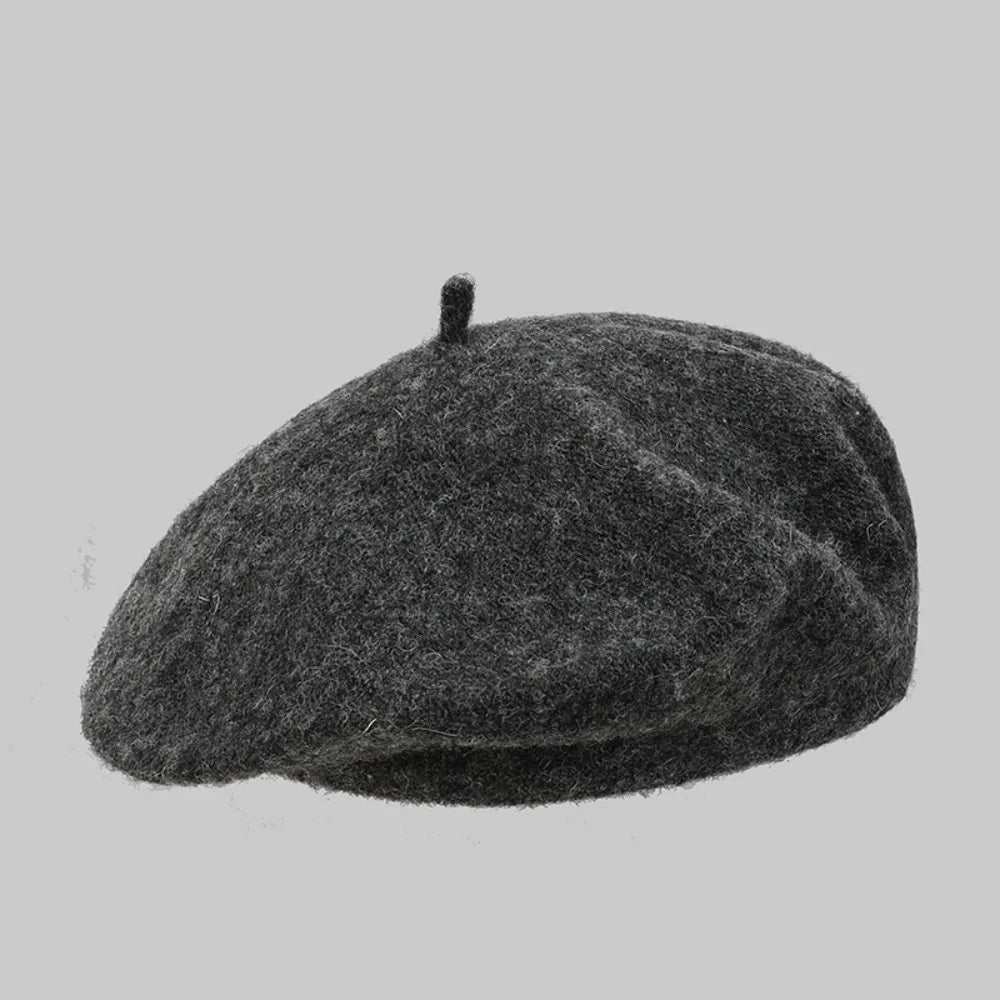 Dark gray wool beret with a small top stem, shown against a plain background