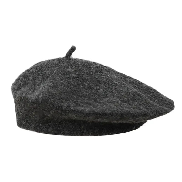 Black wool beret with a short top stem on a white background