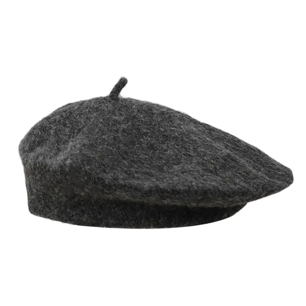 Black wool beret with a short top stem on a white background