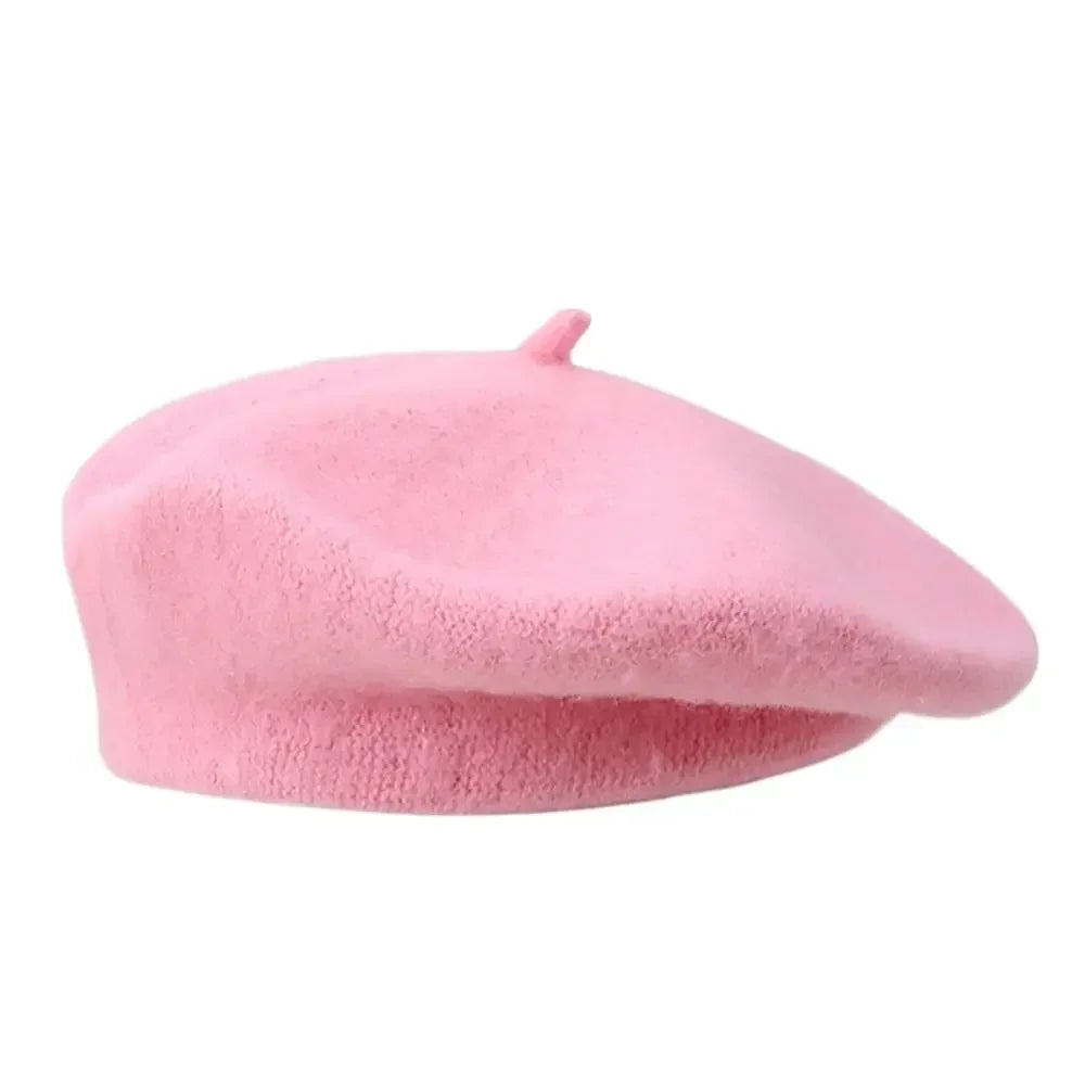 Pink wool beret shown in side view on a white background