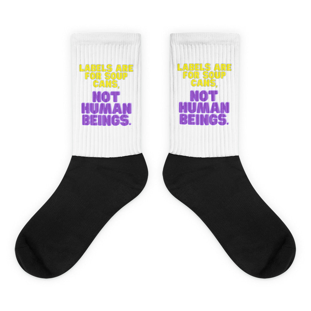 Labels Are For Soup Cans Socks feature a bold black foot and a ribbed white leg with vibrant yellow and purple text