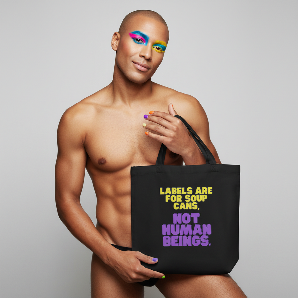Eco tote bag reading "Labels are for soup cans, not human beings," held by a confident person with bold makeup and nails