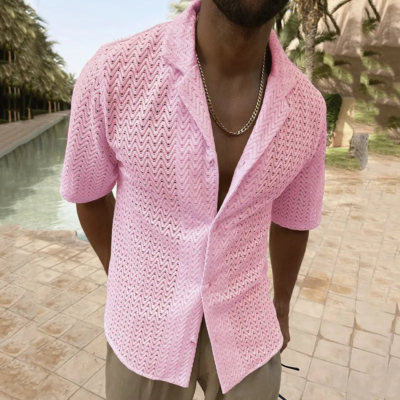 Model wearing a pink open-front lace shirt with short sleeves beside a pool