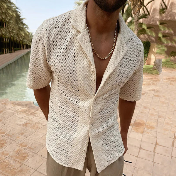 Cropped model wearing an ivory zigzag lace shirt with an open front by a pool