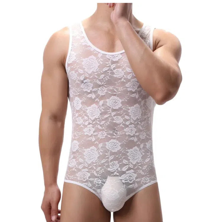 Front view of a model wearing a sheer white floral lace one-piece bodysuit