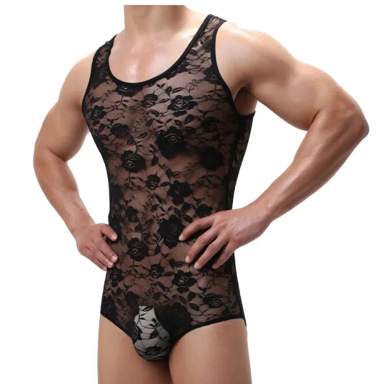Front view of a model wearing a sheer black floral lace one-piece bodysuit