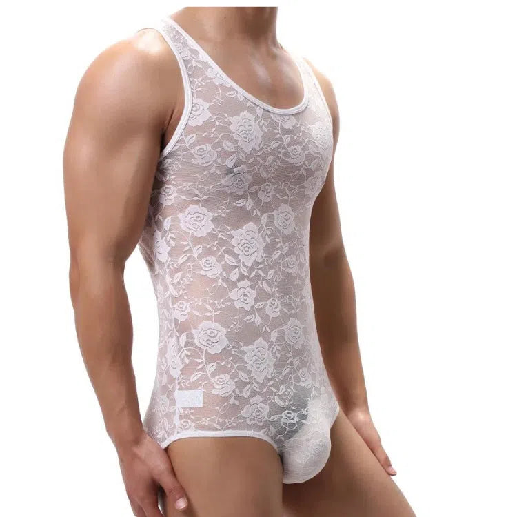 Cropped model wearing a sheer white floral lace one-piece bodysuit, front view