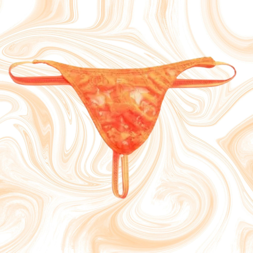 Front-view orange lace thong with multiple thin straps on a swirled cream background