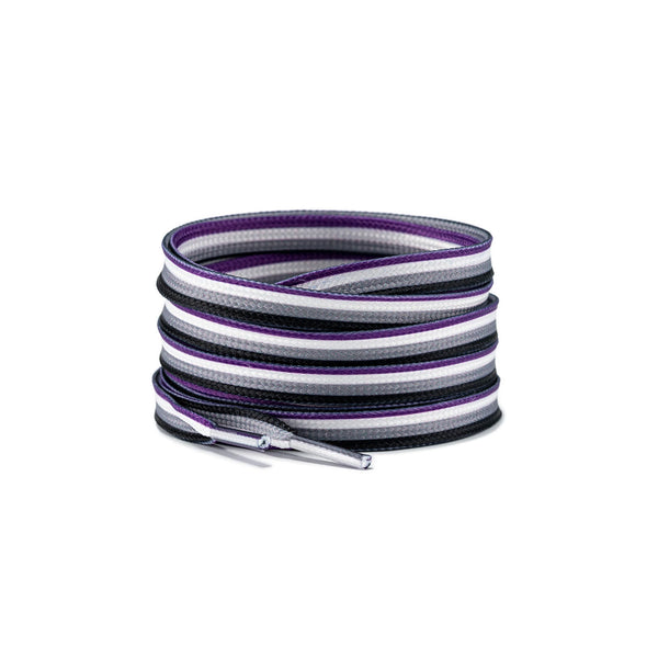Coiled purple, white, gray, and black flat woven shoelaces with metal aglets on white
