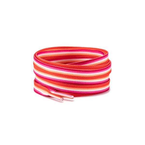 Coiled pink, orange, and white striped shoelaces with two capped ends on a white background