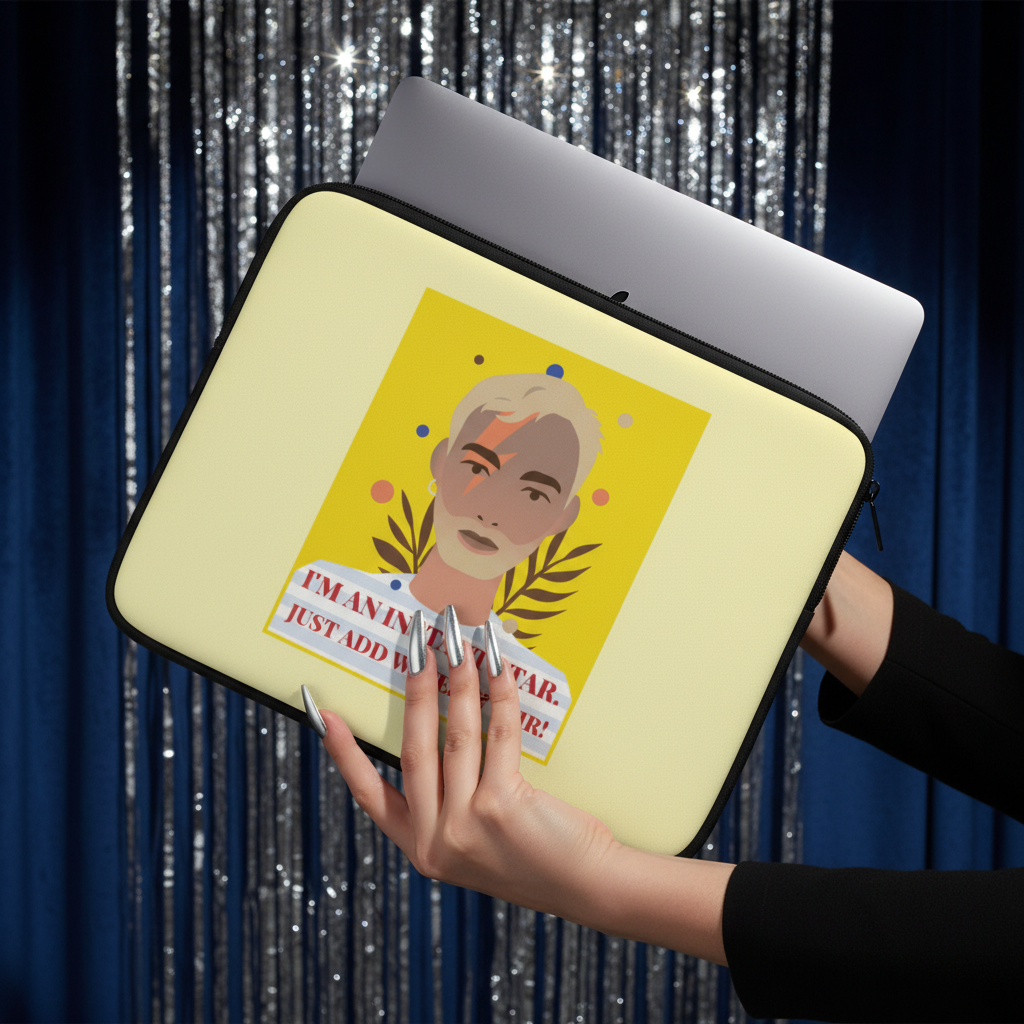 I'm An Instant Star" laptop sleeve—pale yellow neoprene with a bold face graphic, held by long nailed hands; laptop visible, festive tinsel and blue curtains behind.