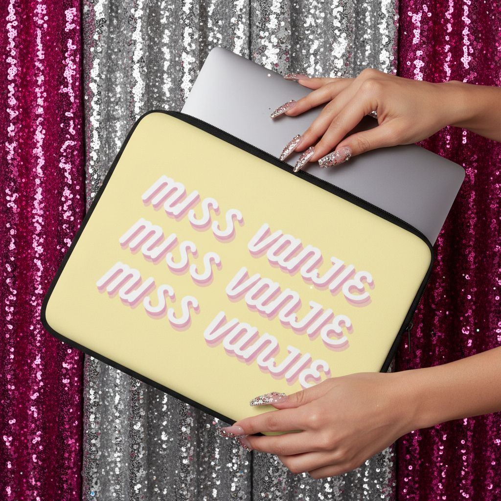 Miss Vanjie Laptop Sleeve in yellow neoprene with “MISS VANJIE” pink 3D letters, glittery nails holding it, silver laptop inside, sparkly pink and silver sequin background.