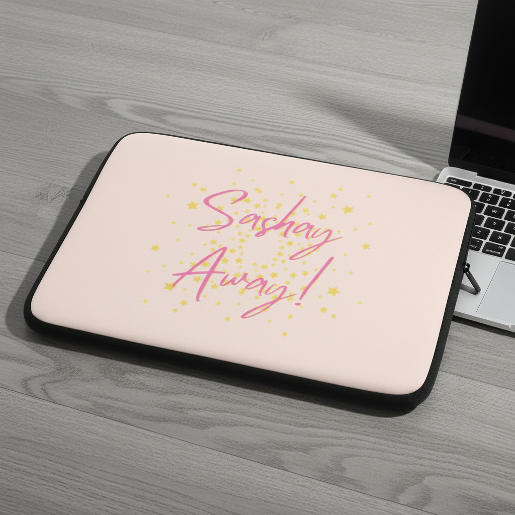 Laptop sleeve made of pink neoprene with black trim, “Sashay Away!” in pink cursive, yellow stars; fab for Pride. On gray desk.