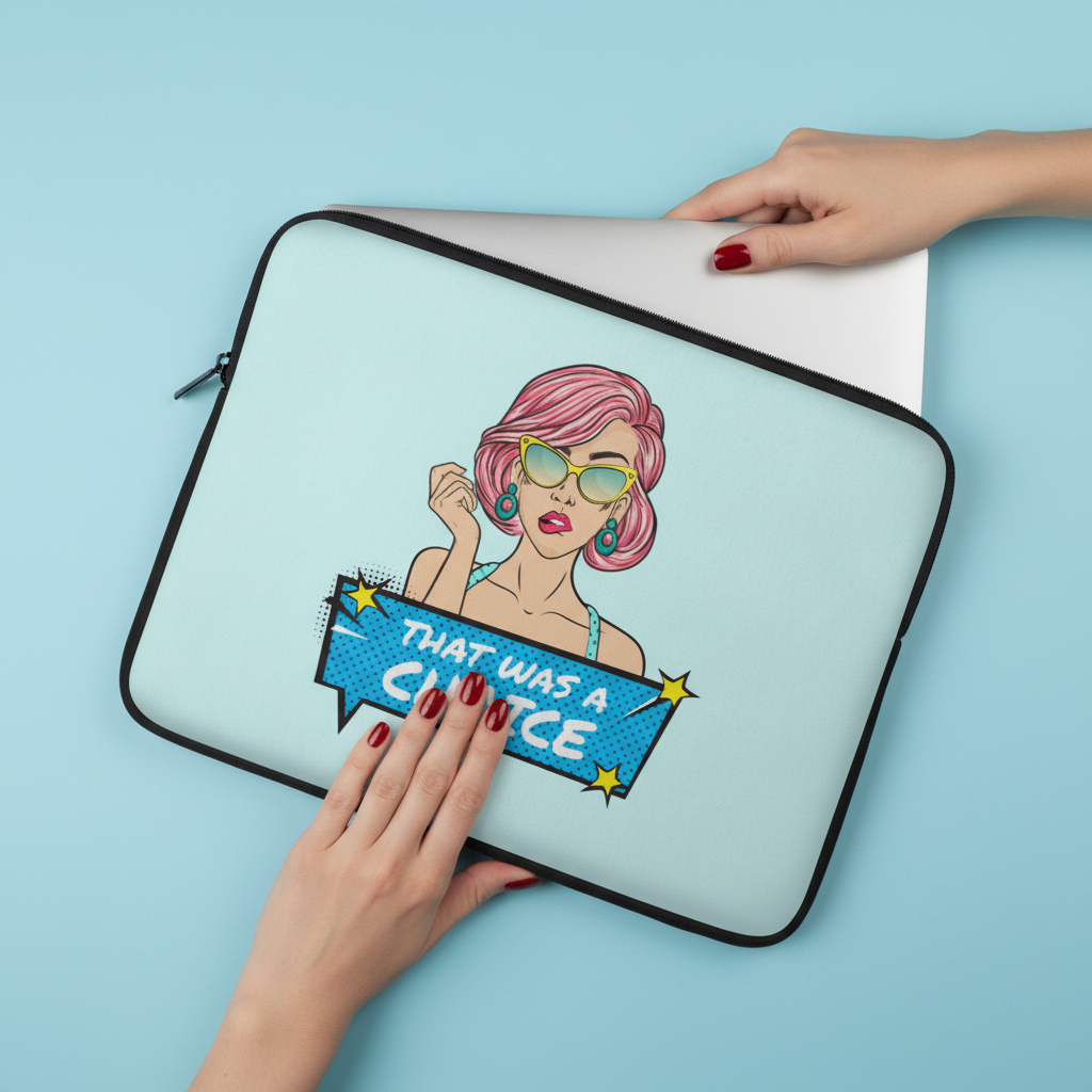“That Was A Choice” Laptop Sleeve in light blue neoprene, featuring a pop art femme with pink hair, yellow shades, and “That was a choice!” in a comic bubble. Red-nailed hands slide in a white laptop.