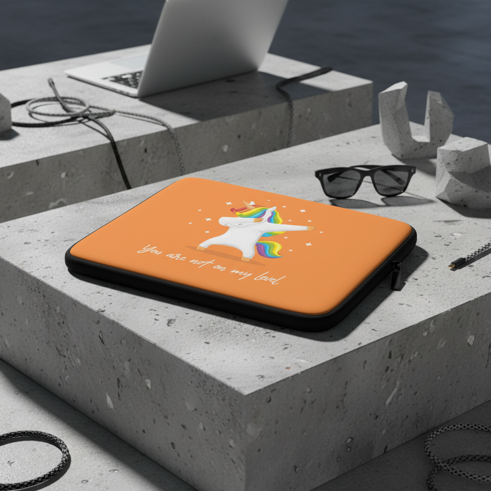 Water-resistant “You Are Not On My Level” laptop sleeve with a vibrant unicorn graphic on concrete; surrounded by sunglasses