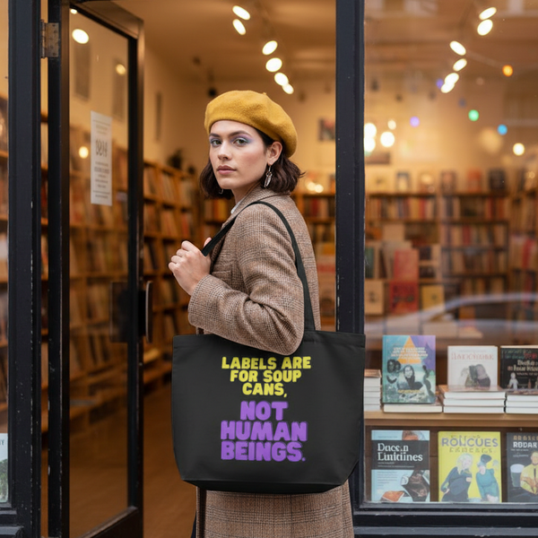 Black tote bag reading “LABELS ARE FOR SOUP CANS, NOT HUMAN BEINGS.”