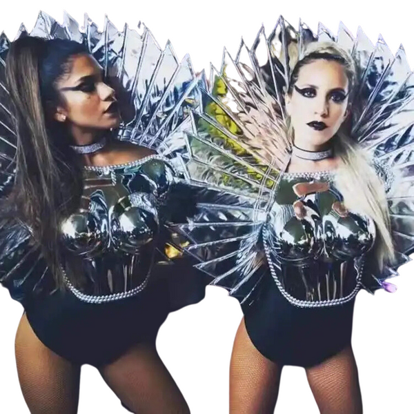 Two models wear metallic black bodysuits with reflective angular collars and fishnet tights