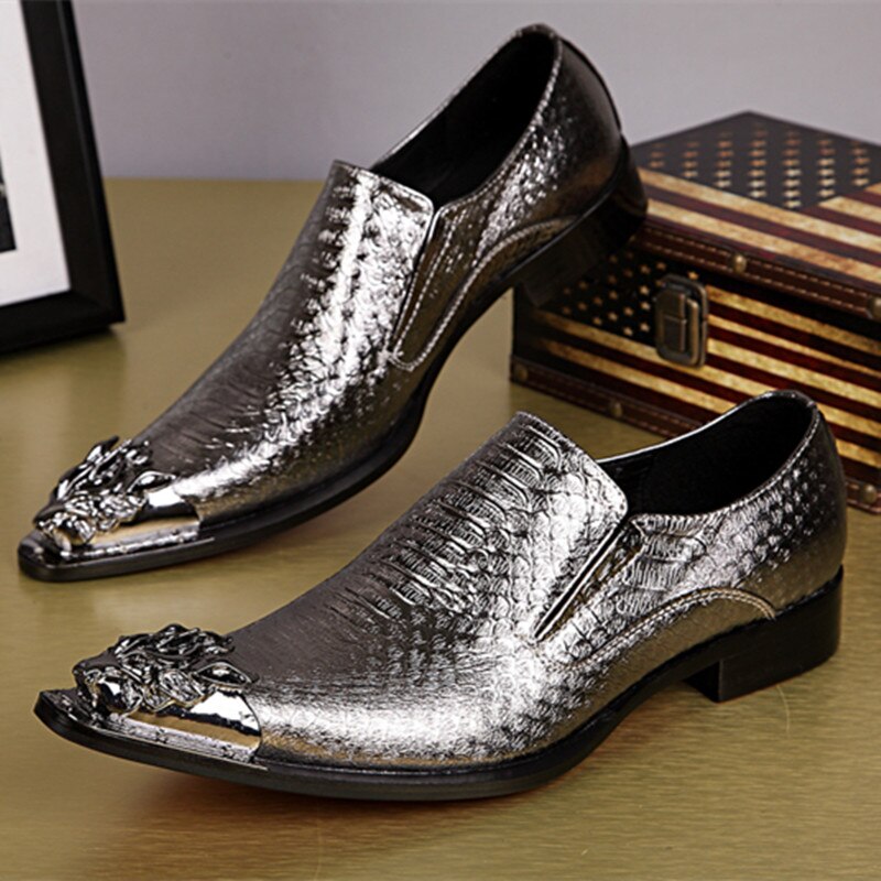 Pair of metallic silver slip-on dress shoes with ornate toe details