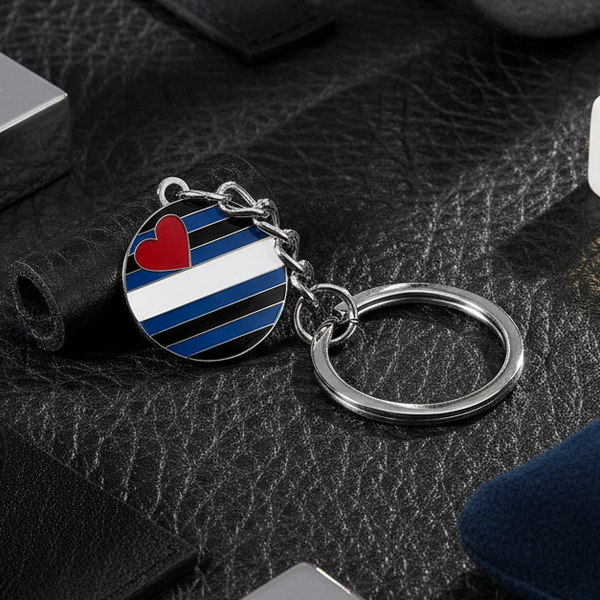 Leather pride keychain with black, blue, and white striped enamel charm and red heart