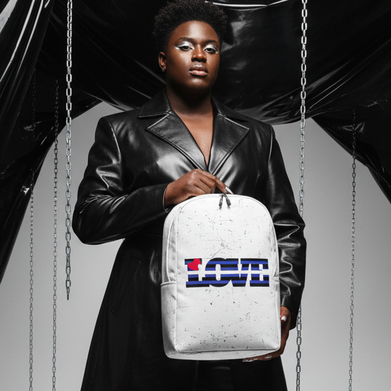 Leather Pride Love Minimalist Backpack with "LOVE" lettering and red heart, shown by a person in black leather; chains