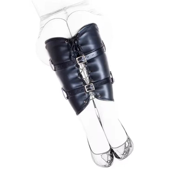 Black leather leg restraint bag strapped around a person's upper legs, viewed from the front