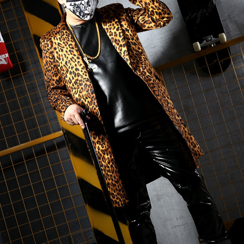 Model wearing a leopard-print coat over a black top and shiny pants