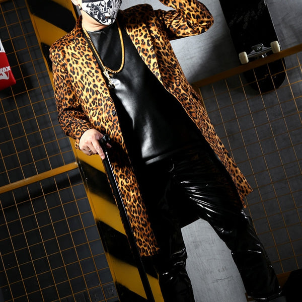 Model wearing a leopard-print coat over a black top and shiny pants