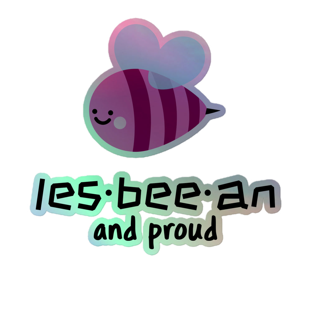 Holographic sticker of a smiling purple bee with heart-shaped wings and “les-bee-an and proud” text