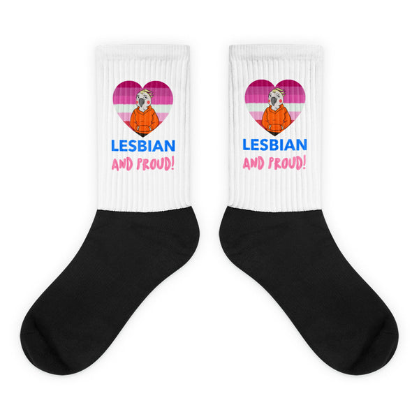 Pair of black-and-white crew socks reading “LESBIAN AND PROUD!” with heart graphics