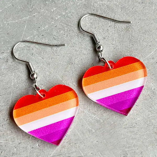 Pair of heart-shaped acrylic dangle earrings with orange, white, and magenta stripes