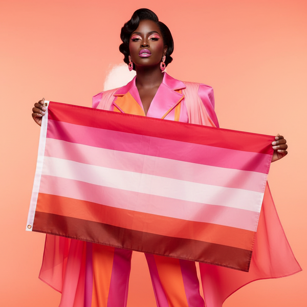 A person proudly displays the vibrant Lesbian Pride Flag, featuring bold red, pink, and white stripes