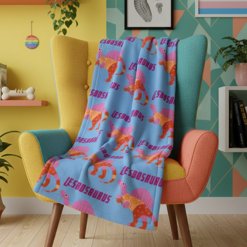 Lesbosaurus Throw Blanket with bold, colorful cartoon dinos and “LESBOSAURUS” text