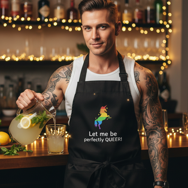 Tattooed bartender pours lemonade while wearing a black apron reading “Let me be perfectly QUEER!”