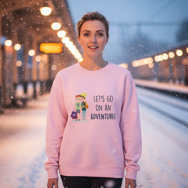 Person wearing a pink sweatshirt reading “LET'S GO ON AN ADVENTURE!” in falling snow