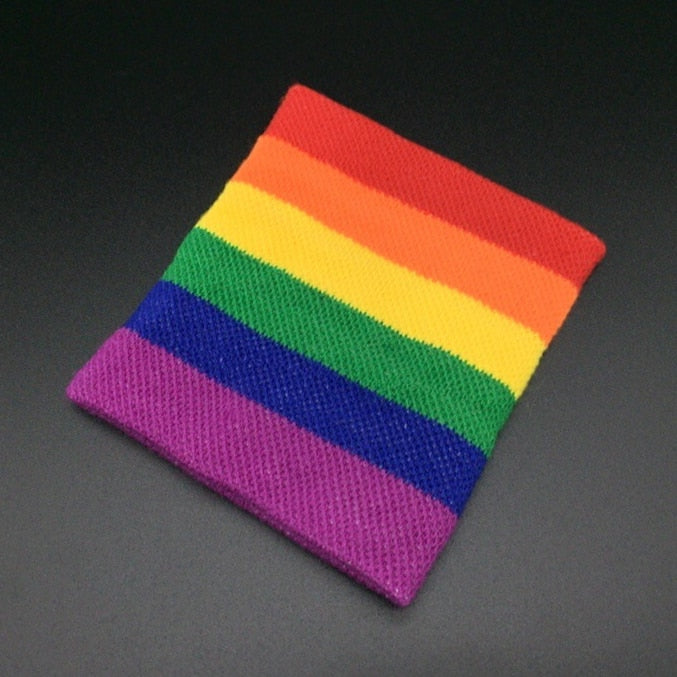 Flat-lay rainbow Pride wristband with red, orange, yellow, green, blue, and purple stripes