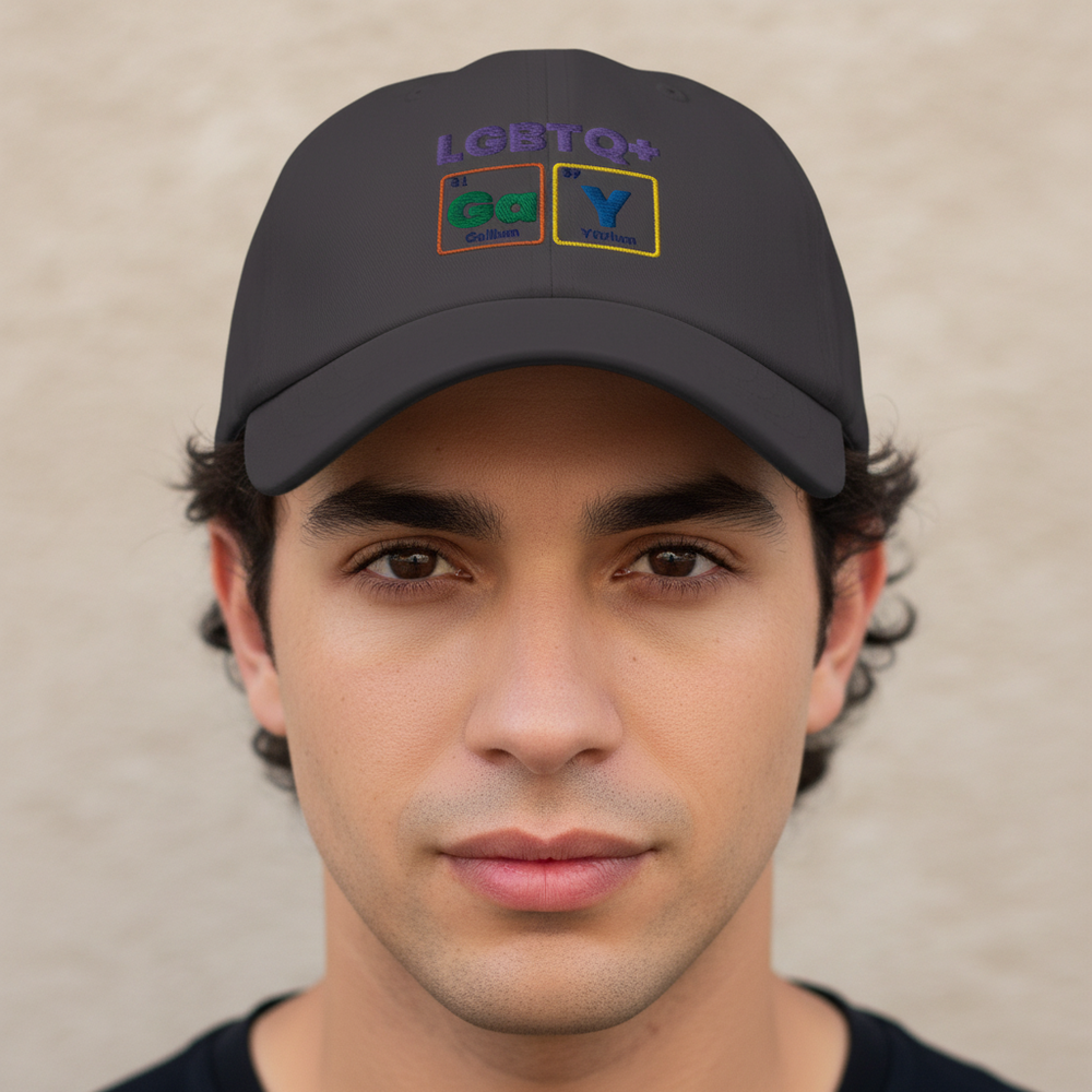 Front-facing model wearing a dark gray cap embroidered “LGBTQ+” and colorful “GaY” blocks