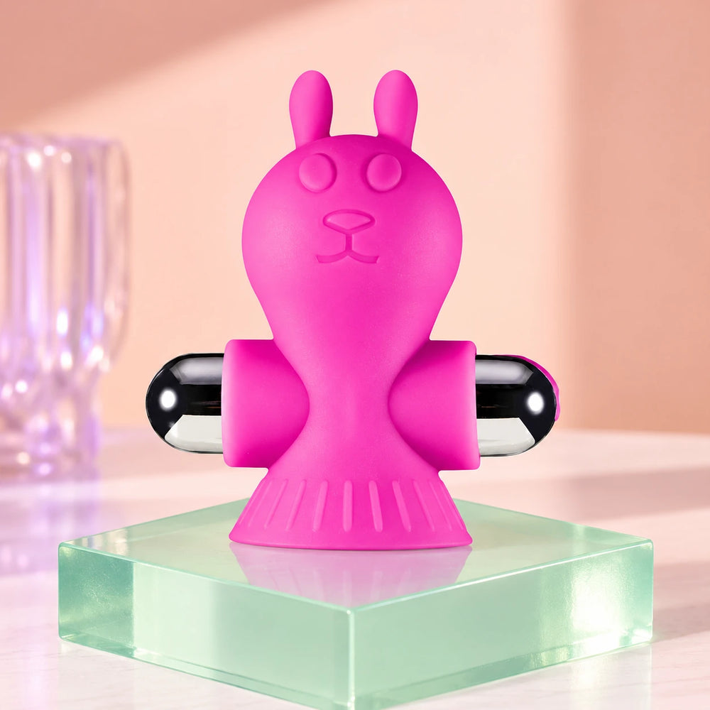 Pink rabbit clamp display showing one pink Liberating Love rabbit-shaped vibrating clamp with black and silver rounded ends.
