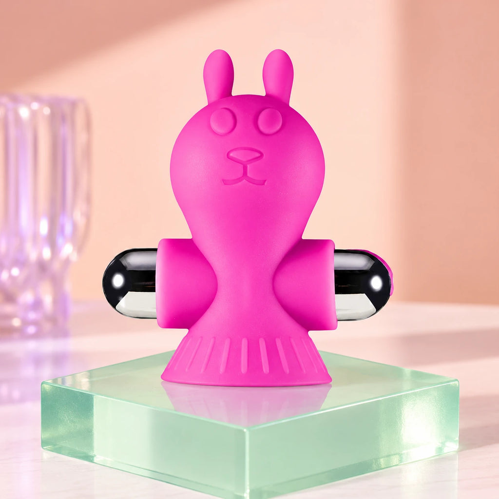 Pink rabbit clamp display showing one pink Liberating Love rabbit-shaped vibrating clamp with black and silver rounded ends.