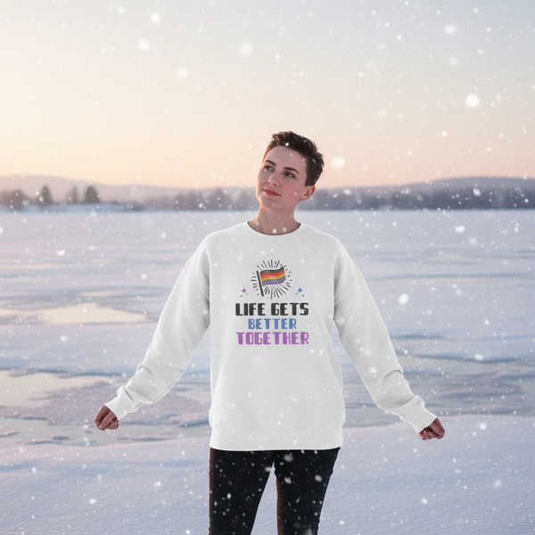 Person wearing a white sweatshirt reading “LIFE GETS BETTER TOGETHER” beside a snowy frozen lake