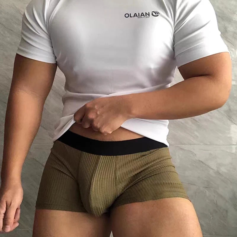 Cropped model wearing olive ribbed cotton boxers with a black waistband